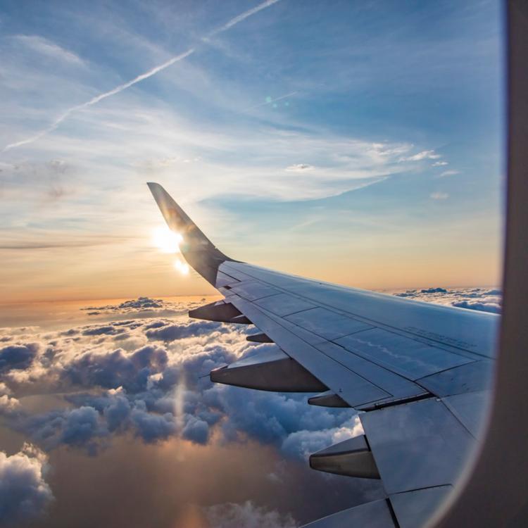 A photo of the sky while looking out the window of a plane